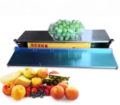 Máquina manual para envolver y empacar alimentos con film transparente. Dispensador de film para frutas y verduras frescas.